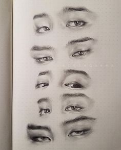 an open book with drawings of eyes and eyebrows on the pages, all drawn in pencil