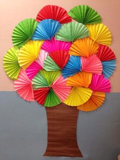 a tree made out of paper with colorful umbrellas on it's top and bottom