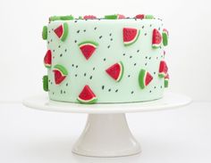 a green cake with watermelon slices on it