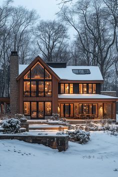 a large house with lots of windows in the snow