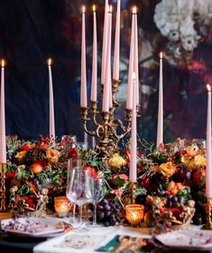 a table topped with lots of candles and plates