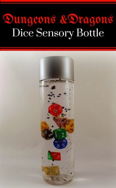 a glass bottle filled with lots of different types of dices and dragon's