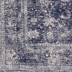 an old rug with faded blue and white colors