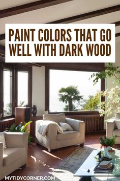 a living room with couches, chairs and windows that read paint colors that go well with dark wood