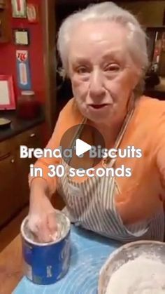 an old woman mixing something in a bowl on top of a blue table with the words brena biscuits in 30 seconds