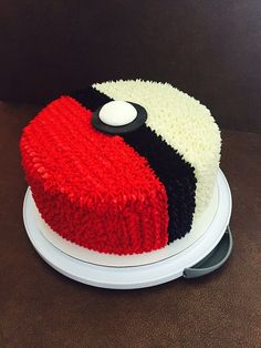 a red, white and black cake sitting on top of a table