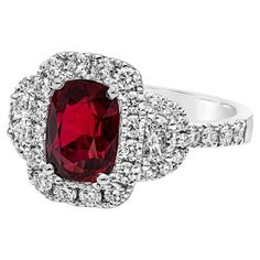 A contemporary piece of jewelry, showcasing a GRS certified color-rich 2.32 carats cushion cut ruby, set on a classic four prong setting. Accented by a halo of round cut diamonds that continue on to the shank in a half-way composition, weighing 0.74 carat total. Flanked by two half moon diamonds weighing 0.29 carat total. Finely made with 18K white gold. Size 6.5 US, resizable upon request. Roman Malakov is a custom house, specializing in creating anything you can imagine. If you would like to r