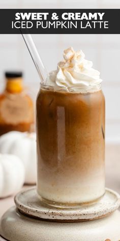 an iced pumpkin latte with whipped cream on top