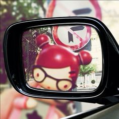 there is a car mirror with a hello kitty image on it