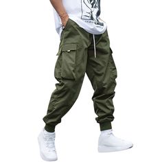 PRICES MAY VARY. Comfortable and Breathable: Made of high-quality polyester, these cargo pants are both comfortable and breathable, making them perfect for everyday wear. Unique Features: These pants feature a street style flap pocket and a casual adjustable drawstring waist with an elastic waistband to snugly hug the waist. Fashionable Flap Pockets: These cargo pants have two unique side pockets that easily accommodate small items, adding a fashionable touch to your outfit. Versatile Occasions: Techwear Cargo Pants, School Workout, Mens Techwear, Casual Techwear, Stylish Street Style, Streetwear Cargo Pants, Cargo Pants Style, Athletic Sweatpants, Outdoor School