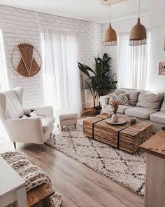 a living room filled with furniture and lots of white pillows on top of a rug