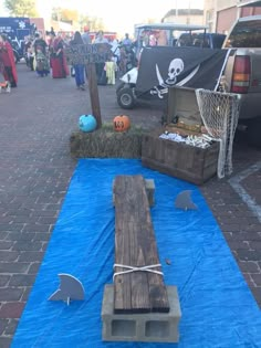 a wooden bench sitting on top of a blue tarp