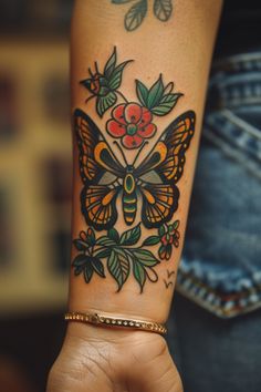 a woman's arm with a butterfly and flower tattoo design on the left wrist