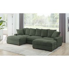 a living room with a large green sectional couch