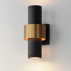 a black and gold wall light on a white wall