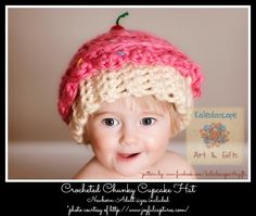 a baby wearing a crocheted hat with an apple on it's top