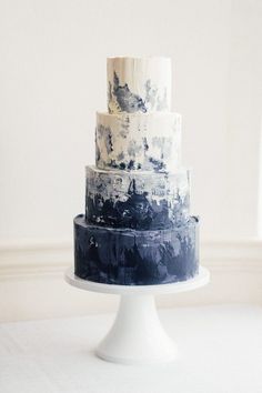 a three tiered cake with black and white designs