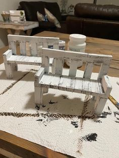 a wooden bench sitting on top of a white rug