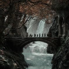 people are walking across a bridge over a river in the middle of a forest with waterfall behind them