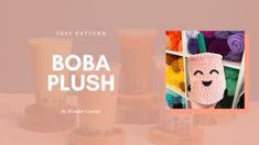 the boba plush is next to some crocheted cups and yarns on display