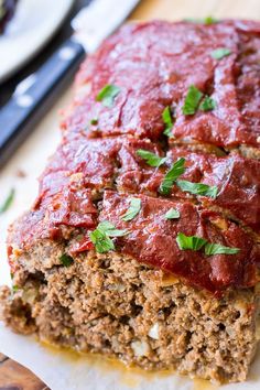 meatloaf with marinara sauce and parsley on top, cut into slices