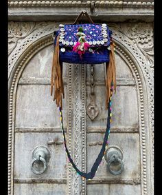 About bag  Indo-gypsy fusion, everyday use hand bag made from Banjara fabrics sourced from Vintage tribal costumes of regions of Rajastan and Gujarat. These are embellished with light catching coins, and intricate bead work tassels. Size - length 15 inches/ width 21 inches Company details:  Company name: Houseoftextile  Contact number: +919784447473  Email id: houseoftextile77@gmail.com  Shipping & custom : Delivery through one of the finest service providers : Skyway, Fedex, UPS  And DHL. Any l Traditional Blue Bags For Festivals, Traditional Blue Shoulder Bag For Festivals, Handmade Blue Shoulder Bag For Festivals, Bohemian Hand-stitched Bags, Blue Rectangular Shoulder Bag For Festivals, Traditional Handmade Blue Shoulder Bag, Blue Embroidered Bag For Festivals, Bohemian Blue Shoulder Bag For Festivals, Bohemian Blue Shoulder Bag For Market