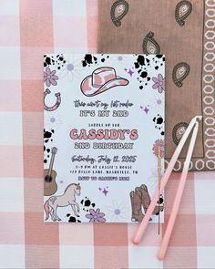 a pink and white checkered table cloth with a cowboy themed birthday card on it