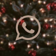 the whatsapp icon is displayed in front of a christmas tree