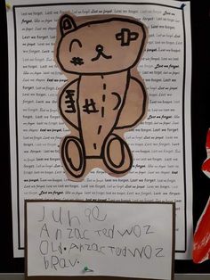 a paper cut out of a teddy bear with chinese characters on it, and a handwritten note