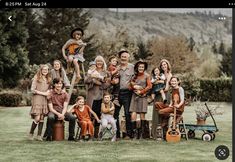 a group of people posing for a photo in the grass with their guitars and instruments