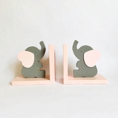 two wooden elephant bookends sitting on top of each other