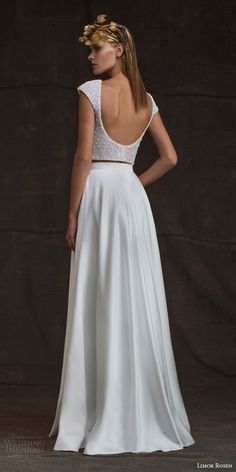 the back of a woman's wedding dress, with her hands on her hips