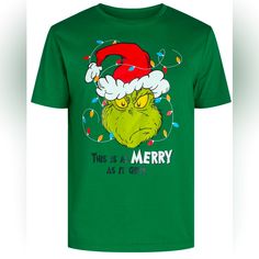 a green t - shirt with an image of the grin face wearing a santa hat