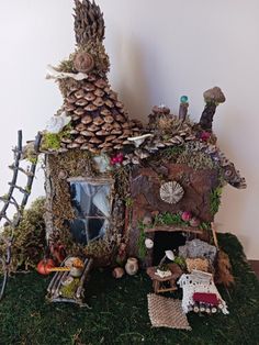 a house made out of moss and pine cones