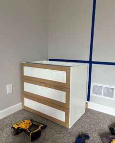 a workbench in the corner of a room with construction tools on the floor