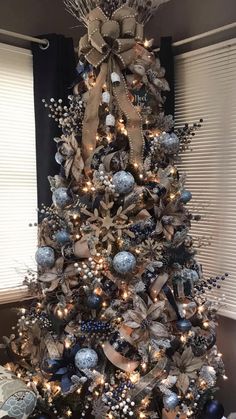 a christmas tree decorated with blue and silver ornaments