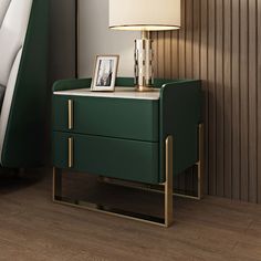 a night stand with a lamp on it next to a green chair and side table