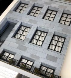 an architectural model of a building with windows and balconies