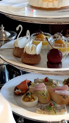 three tiered trays filled with different types of food