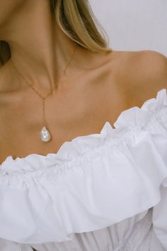 Our Riviera necklace is a classic beauty. Wander down the palm-lined promenade, spend a summers day lying on a deck chair as Nice's beach sparkles in front of you. - 18k gold filled fine chain - Large hand selected luminous freshwater baroque pearl - Gold filled clasp - Gold filled wire - Approx 15 inches in length, with a 3 inch drop Gold filled jewelry is easily 100 times thicker compared to common gold plating & lasts just like gold with proper care. Please keep in mind that each piece is Gold Necklace With Pearl Pendant For Summer, Elegant Beach Pearl Necklace With Pendant, Summer Gold Pearl Necklace With Pendant, Gold Necklaces With Pearl Charm For Summer, Summer Pearl Charm Necklace Gift, Elegant Pearl Drop Necklaces For Beach, Summer Gift Necklace With Pearl Charm, Summer Pearl Pendant Jewelry, Summer Dainty Pearl Chain Jewelry