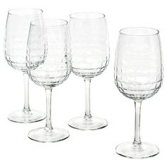 four empty wine glasses sitting next to each other