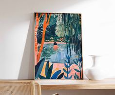 a painting hanging on the wall next to a chair and table with a potted plant