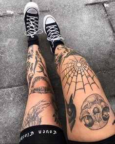 the legs and ankles of a person with tattoos on them