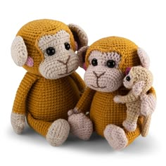 two crocheted monkeys sitting next to each other