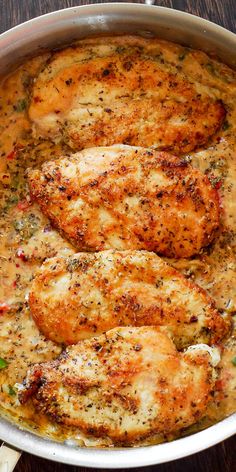 some chicken is cooking in a pan on the table