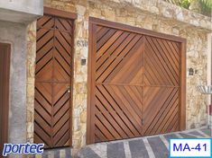 two wooden garage doors in front of a stone building with palm trees on the side