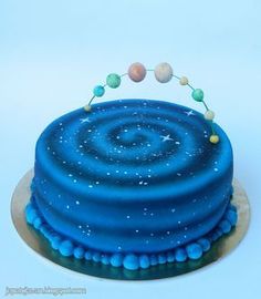 a blue cake with stars and planets on it