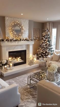 a living room decorated for christmas with white furniture and candles on the fireplace mantel