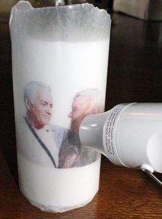 an old man and woman face to face next to a hair dryer on a table