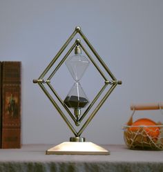 an hourglass sitting on top of a table next to books